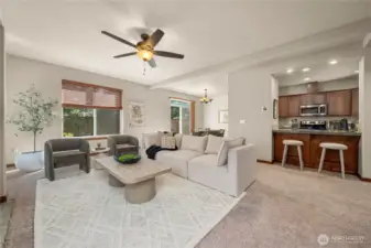 Open floorplan with defined spaces for kitchen, dining and living.