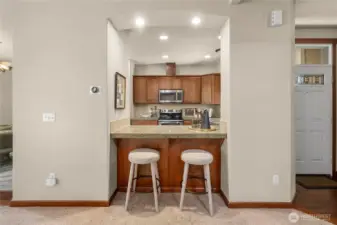 The kitchen features a breakfast bar and granite counters.