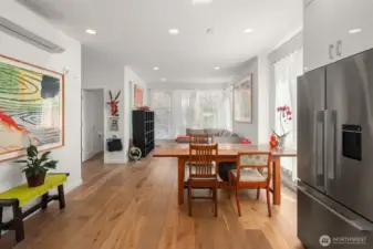 From the kitchen you can see how the interior main spaces communicate in dialog together.  Above the painting on the wall to the left is a mini-split heat and air conditioning unit.  Each floor has its own zoned air controls.