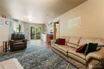 Spacious lower-level bonus room features its own sliding glass door, providing natural light and exterior access.