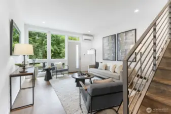 Floor-to-ceiling windows makes this a beautiful space to entertain- enjoy even more square footage with balcony space off living room