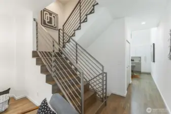 Looking towards the light-filled kitchen- notice large pantry/storage closet on the left past the stairs.