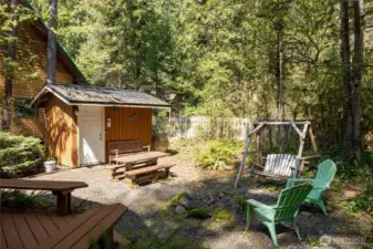 Storage shed plus fire pit area in the backyard.