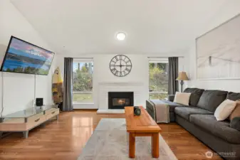 Open space family room with vaulted ceilings and large windows
