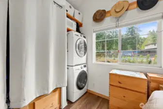 Space-efficient stackable washer and dryer thoughtfully integrated into the bedroom.