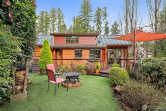 Private backyard with firepit, offering a calm outdoor space to relax and unwind.