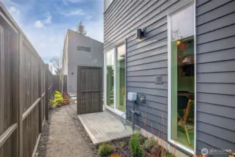 Entry-level guest suite features a large glass slider to a private patio, offering flexible work-from-home potential.