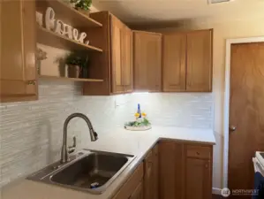 Beautifully updated kitchen with Corian - counters and lovely backsplash!