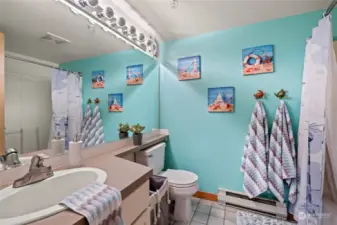 The main bathroom off the hallway is nicely decorated with a great ocean feel.
