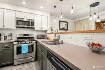 Beautiful kitchen features stainless appliances, contemporary lighting and plenty of room for the chef!