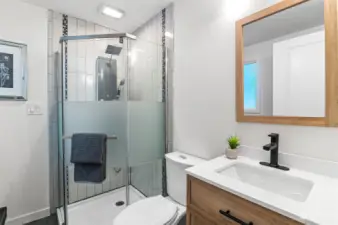 Primary bath features a luxury shower fixture and tile shower, and new vanity.  There is also extra space for storing clothes or other essentials.