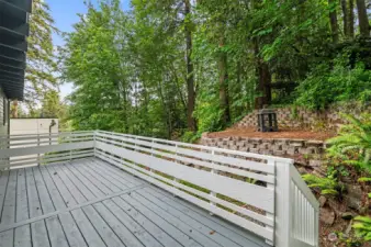 Large deck has been refreshed and colored to match the rest of the home.  The back yard is private and serene with terraced areas.