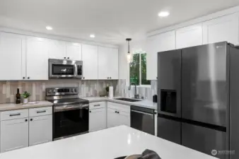 Stainless appliances and quartz countertops.  Lighting fixtures have been updated for easy mood-setting.