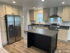 Kitchen with pantry and stainless steel appliances.