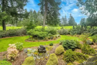 Mature landscaped yard with water feature