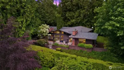 Abundant plantings and mature trees create a lush, curated landscape.