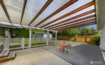 back patio, perfect for entertaining and BBQ cooking, hanging out in theGorgeous covered  big jacuzzi and watching the game on the exterior mounted tv. Also custom fencing for kis playing or pets