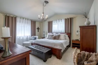 Primary Bedroom has Vaulted Ceilings, nice window for letting in the daylight, a huge walk in closet, 5 piece bath + large vanity.