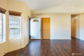 The bay window on the front of the house lets in lots of light. All the windows (except the sliding glass door) have wide, wooden blinds.