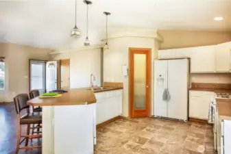 Now you can see the door to the pantry and the refrigerator. The big wide bar is great food prep space.