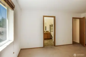 Standing in the corner of the primary suite. The door on the right leads to the hallway.