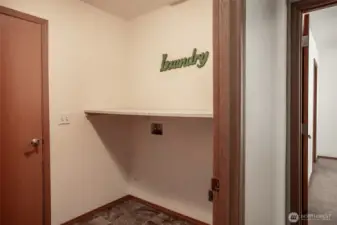 A very necessary room. Washer and dryer fit into this space with cleaver shelf above. Door leads to the generous 2 car garage.