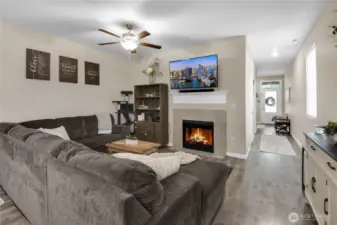 The hall opens to the spacious living room and kitchen.  You'll love the high ceilings and natural light!