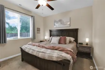 Primary bedroom with ceiling fan.
