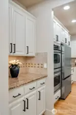 A butler's pantry provides added storage and to the right, is a large walk-in pantry! Everyone's favorite.