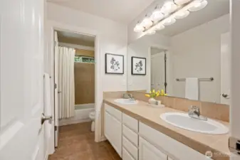 Large guest bathroom with dual vanities, ample storage!