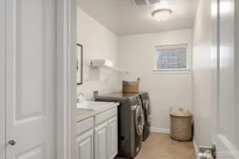 Upstairs Utility Room with linen closet and utility sink makes doing laundry easy & efficient.