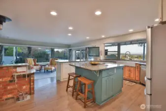 Beautiful open kitchen and living room looking out to the valley and Mt. Rainier.