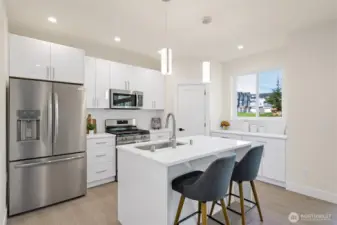A beautiful kitchen with bar seating.