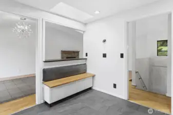 From the entry to the main level, the kitchen features a built-in corner bench—ideal for setting down groceries or casual seating