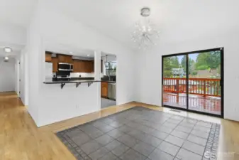 Enjoy a large dining room with a charming glass chandelier, flowing into an open kitchen with bar space for gatherings.