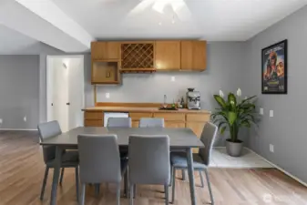 Lower-level family room with view of wet bar-Virtually staged. Furniture and décor shown are for illustrative purposes only.