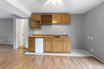 Closer view of the wet bar area, complete with mini refrigerator & wine cabinet.