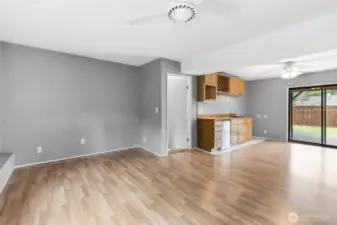 Spacious lower-level family room with ceiling fan, wet bar, wine cabinet, and patio access—perfect for entertaining or family time.