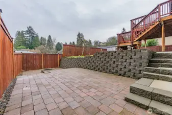 Charming brick entertainment space with a cozy firepit—perfect for gatherings.