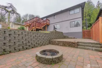 Brick patio with firepit, ideal for entertaining.    Photos have been virtually staged. Furniture and décor shown are for illustrative purposes only.