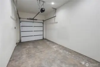 Private garage is plumbed for EV.  High ceilings make for future storage options