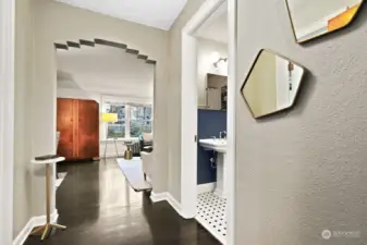 Enter the condo to ebony stained hardwoods and Deco arched doorways, truly lovely!