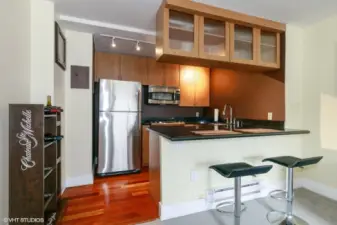 Stainless steel appliances and bar seating.