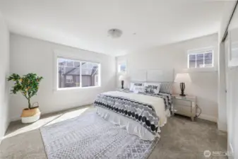 Spacious primary suite on upper level with ensuite bath, a regular closet and another walk-in closet.