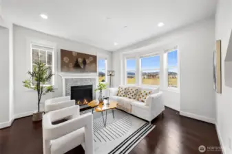 Living room with large windows and gas fireplace.