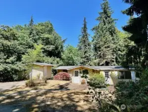 The vintage cottage on it's 1+ acre high bank waterfront lot