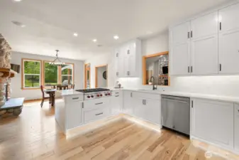 The new kitchen has under cabinet lighting and a 6-burner gas Wolf stove. The other appliances are top-tier Jen Aire