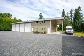 The ADU entrance is through the side door, attached to the shop. It is a 1-bed, 1-bath with kitchenette. There are large covered areas for storage on the back of both shops