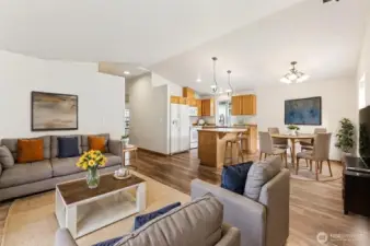 The vaulted ceilings, open floor plan and lots of natural light make the space feel larger than it is. This photo is virtually staged.