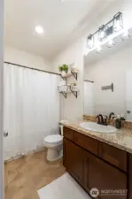 Guest Bathroom with tub/shower combo. Granite countertops.